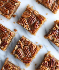 several pecan bars are arranged on a marble surface