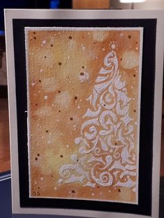 a handmade christmas card with a white tree on the front and black border around it