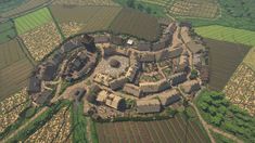 an aerial view of a small village surrounded by fields