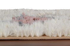 a rug with white feathers on top of it