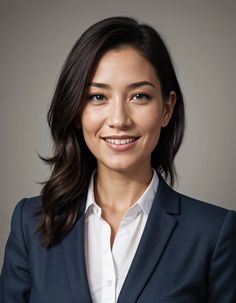 a woman in a business suit smiling at the camera