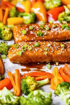 broccoli, carrots, and other vegetables on a sheet of parchment paper