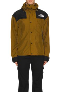 Self: 100% polyester, Lining: 100% polyester.  Made in Vietnam.  Machine wash.  Zip and snap button front closure.  Side zippered vent holes.  Interior zip pockets.  Gore-Tex waterproofing.  .  .  .  .  .  .  .  .  . Mountain Jacket, North Face Mens, Gore Tex, Snap Button, Side Zipper, The North Face, Zip Pockets, Vietnam, Zipper