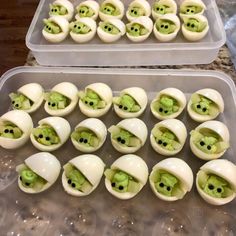 there are many deviled eggs with green eyes in them