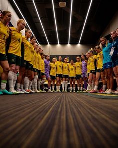 a group of women's soccer players standing in a line