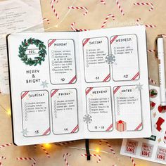 an open christmas planner on top of a table with candy canes and other items