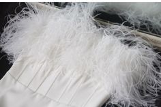 a white dress with feathers on it