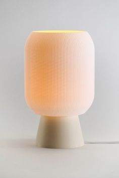 a white lamp sitting on top of a table