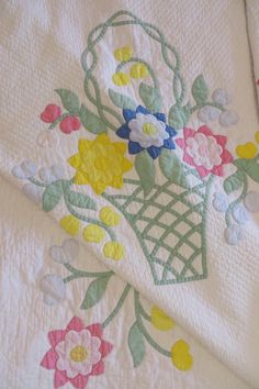 a quilted blanket with flowers on it