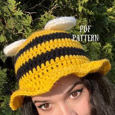 a woman wearing a crocheted bee hat