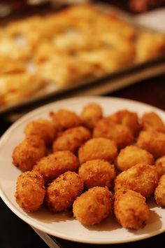 some fried food is on a white plate and ready to be eaten by someone else