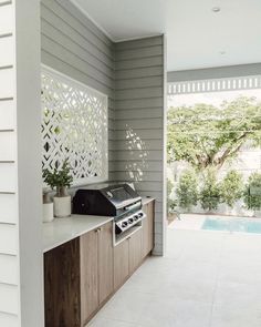 an outdoor kitchen with a grill on the counter