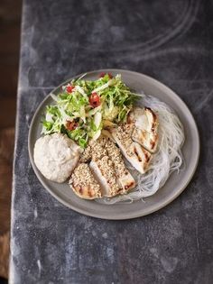 a white plate topped with meat and veggies