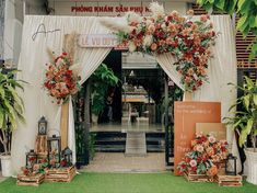 an entrance to a flower shop decorated with flowers