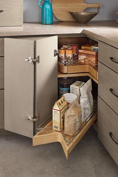 an open cabinet in the corner of a kitchen