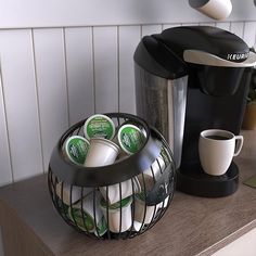 a coffee maker sitting on top of a counter next to a cup