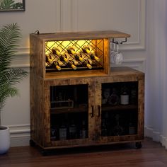 a wooden cabinet with wine bottles in it and a potted plant next to it