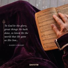 an old woman is reading a book with her hands