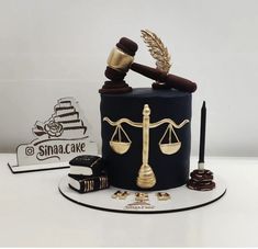 a cake made to look like a judge's gavel and scale with chocolates