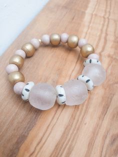 Soft pink recycled glass bracketed by gold and rise wooden beads Pink Glass Beaded Bracelets, Pink Wooden Bead Bracelet Jewelry, Pink Wooden Beads Bracelet Jewelry, Pink Wooden Beads Bracelet, Pink Wooden Bead Bracelet, Diy Essential Oils, Glass Bracelet, Recycled Glass, Wooden Beads