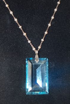 I love the large jewel on this necklace! It is 1 1/2 inches by 7/8 inch and has a sterling bale. The necklace is sterling and has French hallmarks on the catch. The tiny pearls are made of glass and are not real. The chain length is 15 1/2 inches. The total effect is just lovely. In nice condition with some tiny flea bits to the jewel. French and C. 1930. Follow me on instagram @jettesjewels Elegant Collectible Necklaces With Rectangular Pendant, Formal Blue Necklace With Pearl Pendant, Art Deco Pearl Pendant Necklace As Gift, Art Deco Pearl Pendant Jewelry For Gift, Formal Blue Pearl Pendant Jewelry, Formal Blue Jewelry With Pearl Pendant, Faceted Silver Pearl Necklace For Gift, Vintage Blue Necklace With Pearl Pendant, Blue Pendant Necklace With Pearl Drop