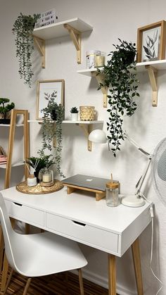 a white desk with some plants on it