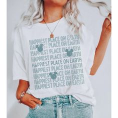 a woman wearing a white shirt with the words happiest place on earth printed on it