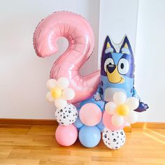 an animal themed birthday party with balloon decorations and balloons in the shape of numbers 2