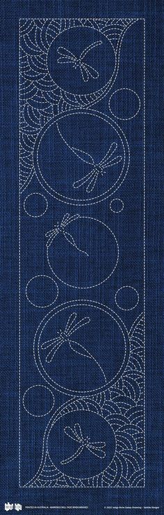 the back side of a piece of blue fabric with white thread on it and an image of