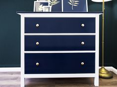 a blue and white chest of drawers in a room