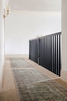 a room with a rug, radiator and lamp on the wall next to it