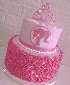 a pink and white cake with a princess crown on top