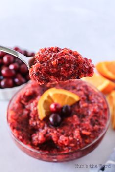 a spoon full of cranberry sauce with orange slices