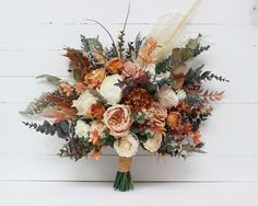 a bridal bouquet with orange and white flowers