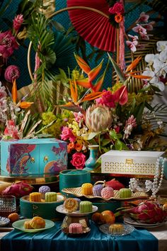 a table topped with lots of cakes and desserts