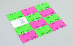 a pink and green piece of paper with words on it