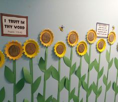 a bulletin board with sunflowers on it and some paper flowers in the middle