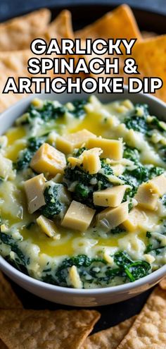 a bowl of spinach and artichoke dip with tortilla chips