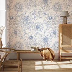 a room with a table, chair and flower wallpaper