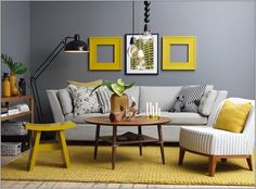 a living room with gray walls and yellow accents