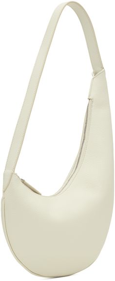 Grained calfskin shoulder bag in off-white. · Piping throughout · Fixed shoulder strap · Logo embossed at face · Zip closure · Patch pocket at interior · Faille lining · H8.5 x W12 · Total height: H18 Supplier color: Grain white White Smooth Grain Shoulder Bag For Daily Use, Modern Cream Textured Leather Shoulder Bag, Daily Use White Smooth Grain Shoulder Bag, Cream Textured Leather Crossbody Shoulder Bag, Piping, Mini Bag, Patch Pocket, Calf Skin, The Face