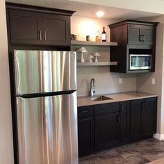 a metallic refrigerator freezer sitting inside of a kitchen