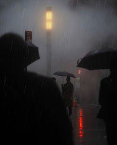 several people walking in the rain with umbrellas and lights behind them on a rainy night