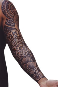 a man's arm with an intricate tattoo on it