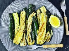 grilled zucchini on a plate with a fork