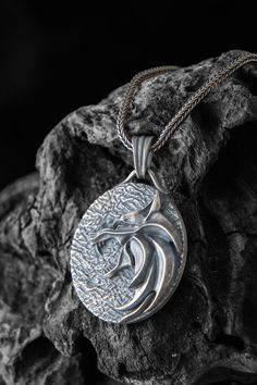 The silver wolf pendant is a stunning piece of jewelry that is perfect for fans Wolf lovers. Crafted from high-quality silver, this pendant features a beautifully detailed wolf head, a symbol that is closely associated with the Witcher universe. The intricate design and attention to detail make this pendant a truly unique and eye-catching accessory that is sure to draw compliments. Whether you wear it as a statement piece or as a subtle nod to your fandom, this pendant is a must-have for any Wit Wolf Medallion, Wolf Pendant Necklace, Black Chain Necklace, Wolf Pendant, Wolves Pendants, Wolf Necklace, Wolf Jewelry, Silver Wolf, Wolf Head