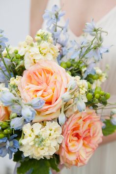 a bride holding a bouquet of flowers in her hands