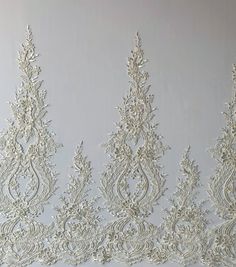 three white lace trims on a wall