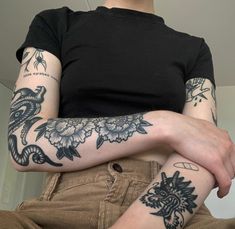 a woman with tattoos on her arms and legs