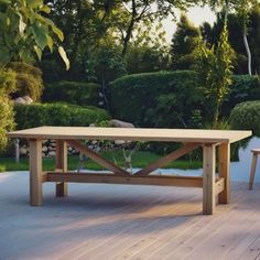 a table and two chairs on a deck in the middle of a garden with trees